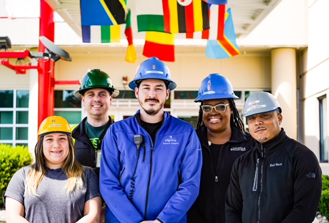 Group of five people in hard hats